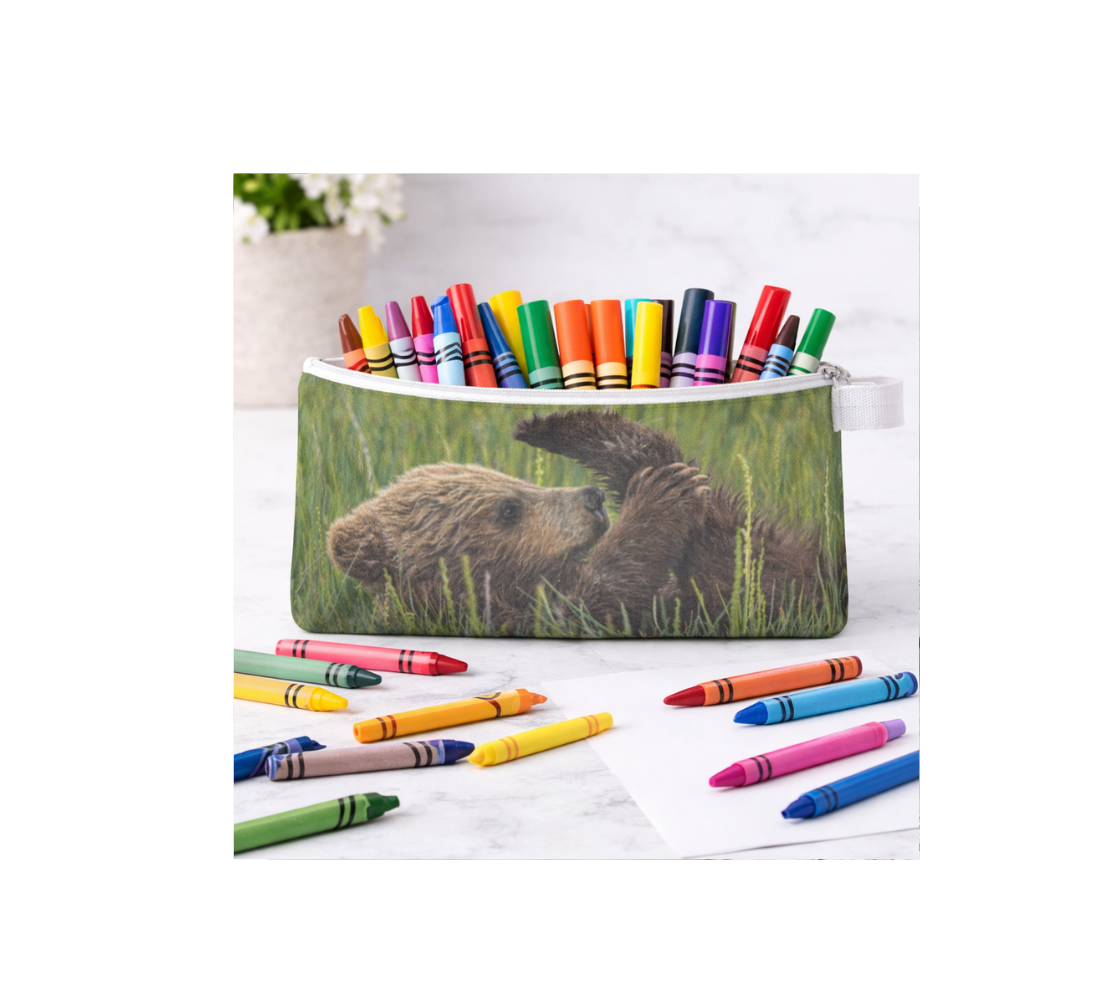 Zippered pouch with a brown bear cubs design with crayons inside it on a white background.