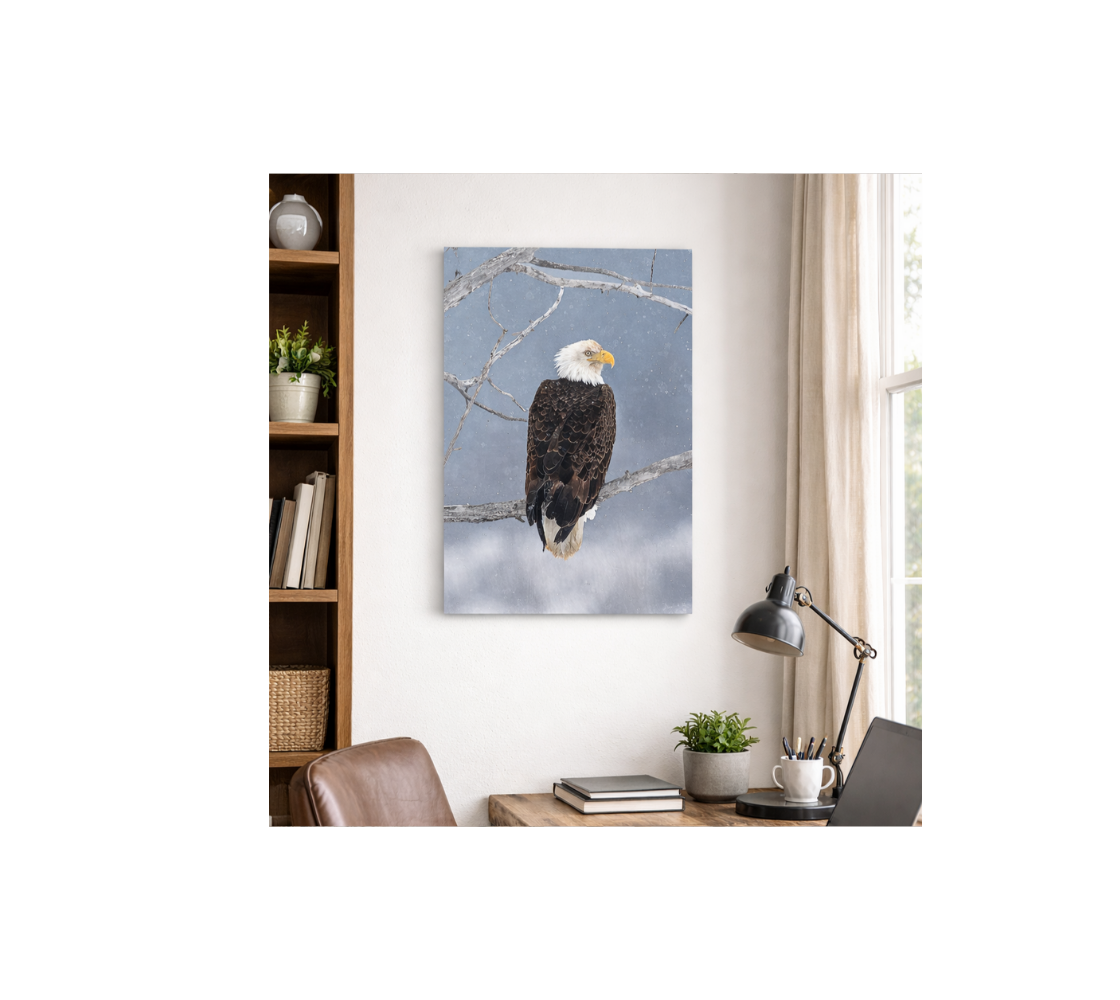 A portrait metal print of our photograph featuring bald eagle with a blue sky background on a wall in a home office setting.