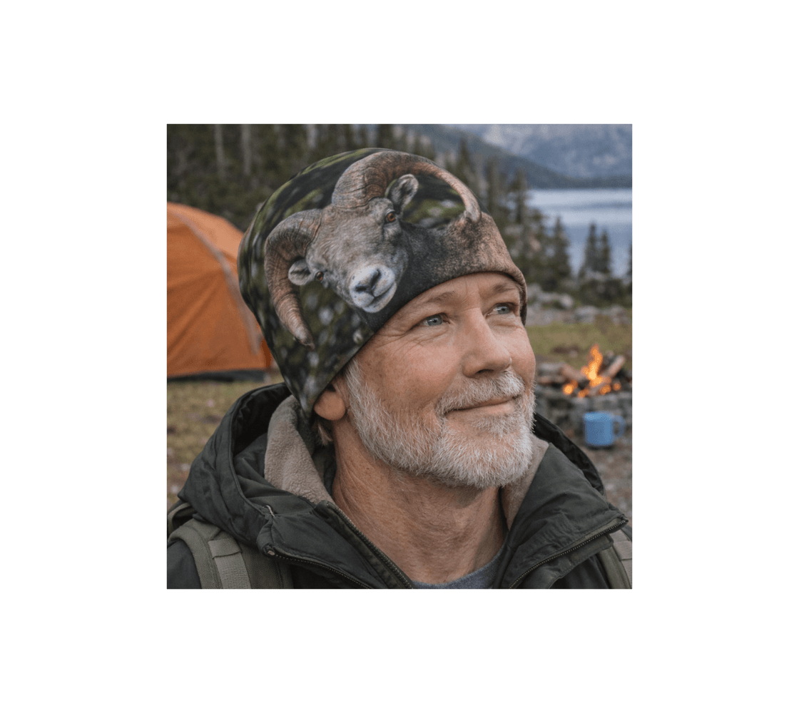 A man wearing a bighorn ram bamboo-lined beanie from our real wildlife photography camping in a forest setting.