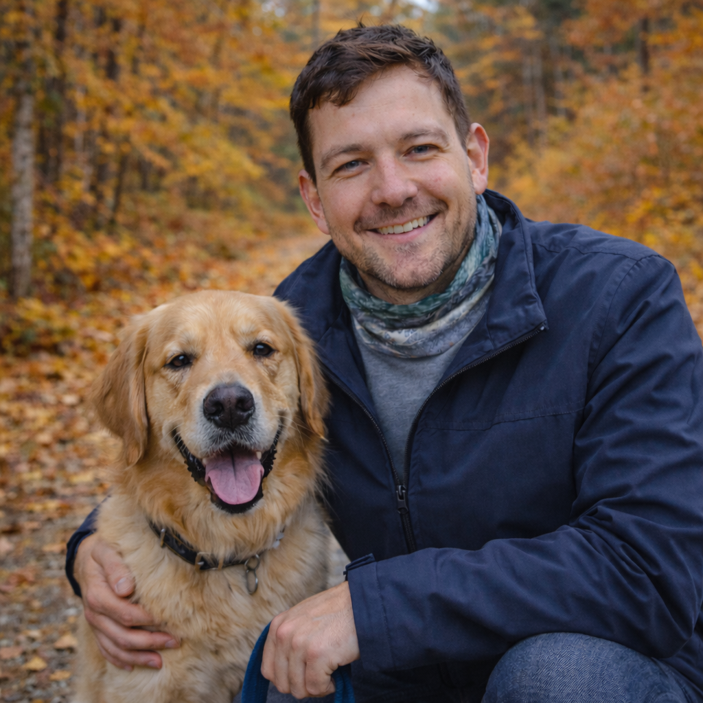 A man and his dog in an autumn forest wearing a head and neck buff around his neck with an image of a bull moose design with a blue and green background.