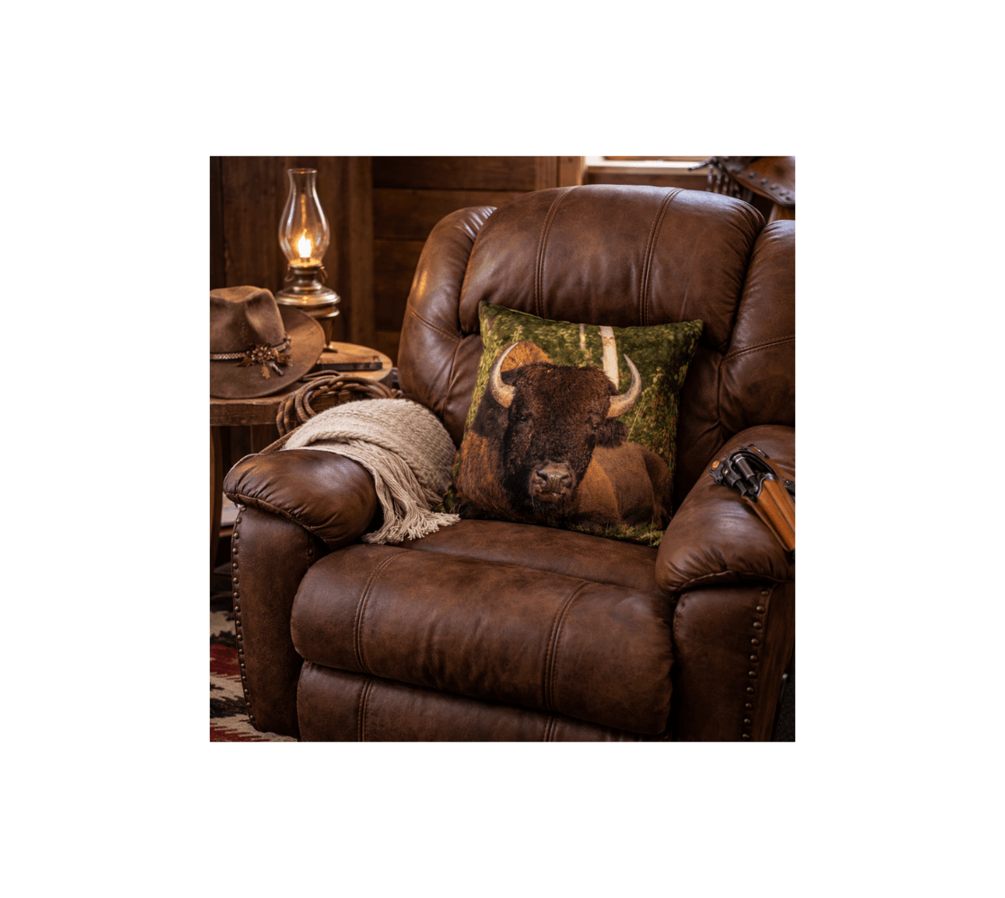 A rustic living room with a bull wood bison decorative throw pillow cover from our real wildlife photography on a brown leather chair.