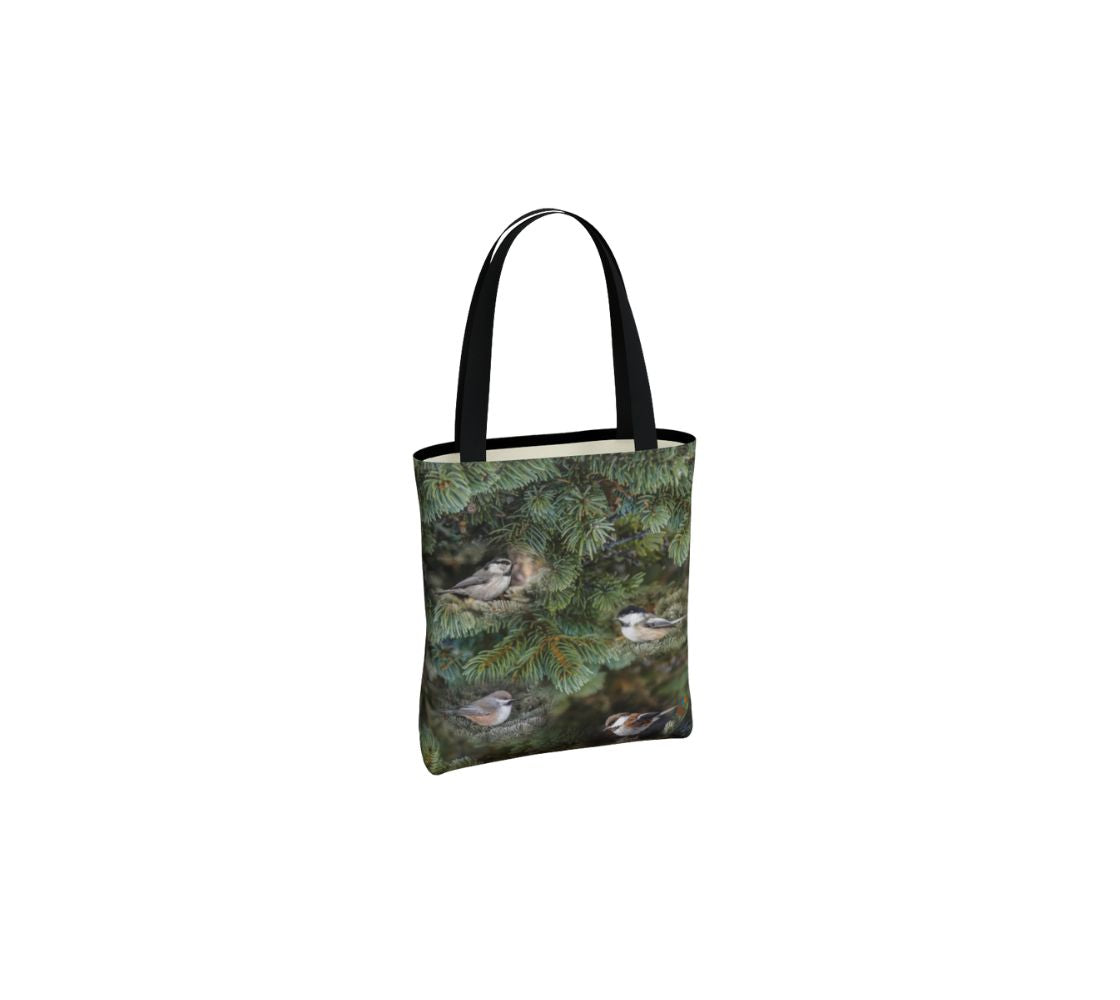 This is an image of small canvas market bag featuring the same photo on each side of green tree boughs in the background with a repeating photo collage of the four different chickadees of Western Canada in their colorful black, brown, white, rust and grey tones. The bag has two 1.5" wide black straps with a white interior.