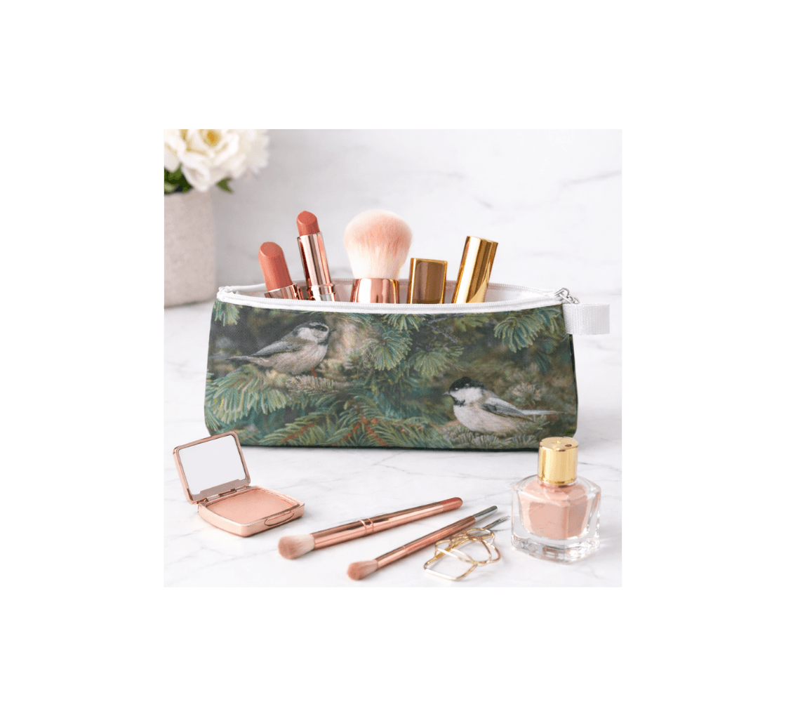 A zippered pouch with a chickadee design from our wildlife photography with makeup items inside it.