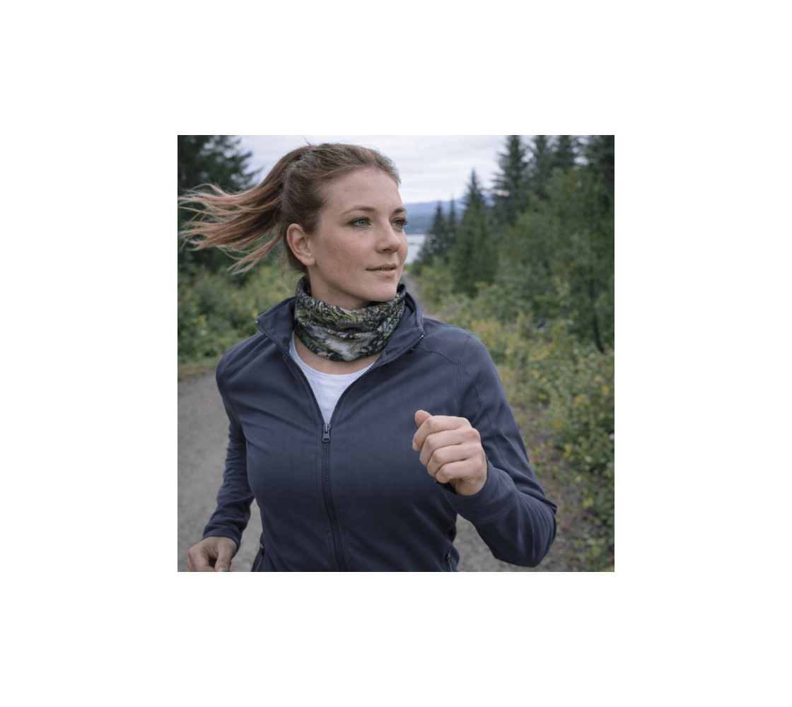 A woman jogging wearing a gray wolf head and neck buff from our wildlife photography around her neck.