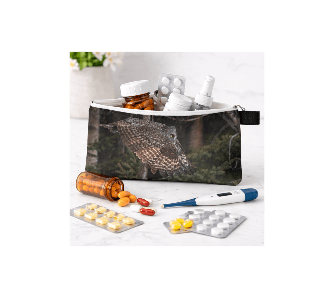 A zippered pouch with a great gray owl design from our wildlife photography with medical supplies inside it.