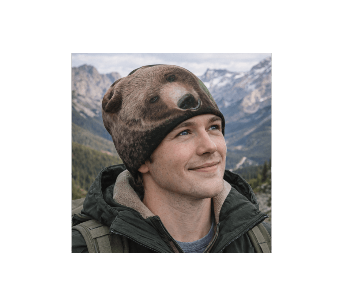 A man standing in the mountains wearing a grizzly bear bamboo-lined beanie from our wildlife photography.