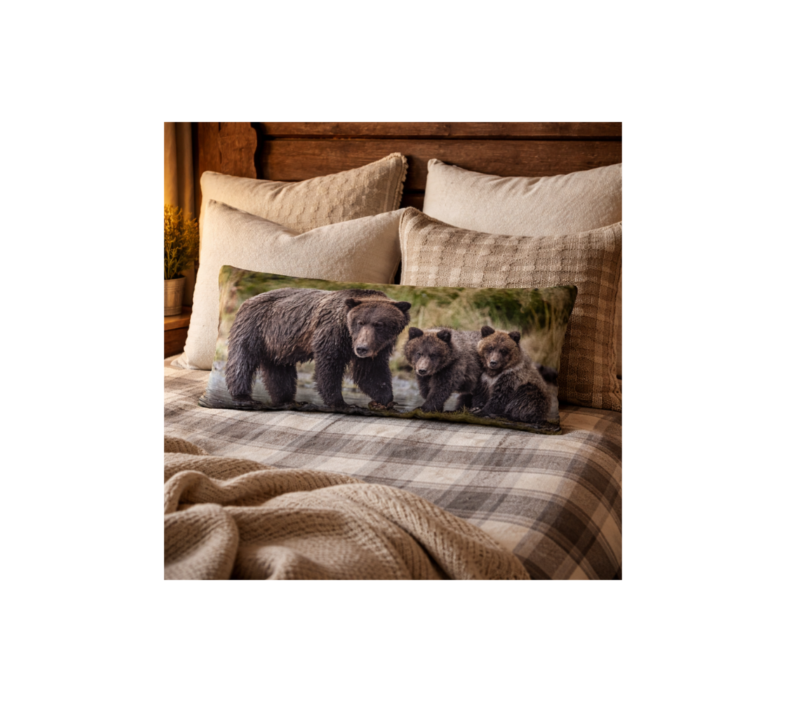 A bed room with a grizzly bear and her cubs decorative long throw pillow cover from our Canadian wildlife photography on a bed.