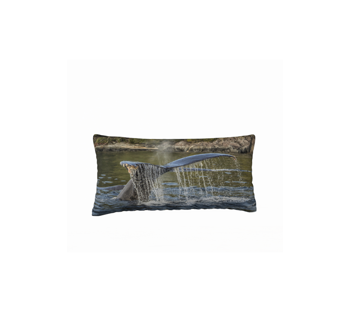 A decorative long throw pillow cover with our photograph of a humpback whale tail design with a coastal background.