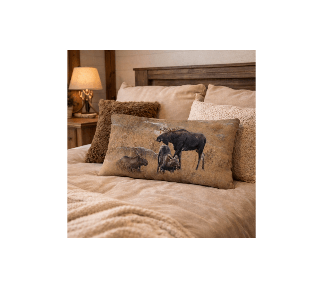 A bedroom with a moose decorative long throw pillow from our real wildlife photography on a bed.