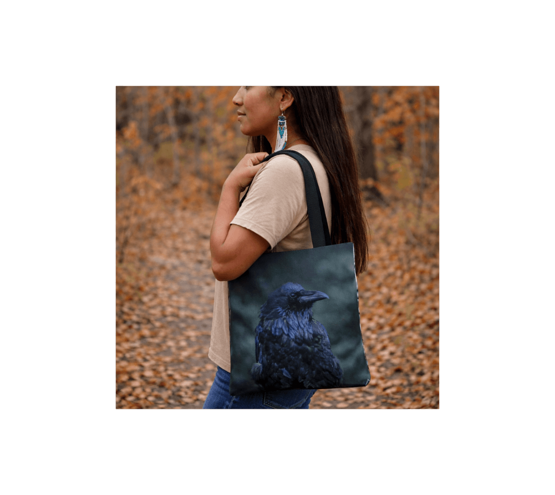 A woman carrying a raven medium reusable tote bag from our real wildlife photography standing in a forest.