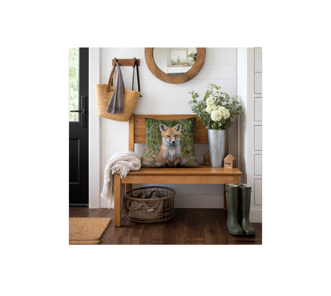 A front door Entryway with a red fox kit decorative throw pillow cover from our real wildlife photography on a wooden bench.