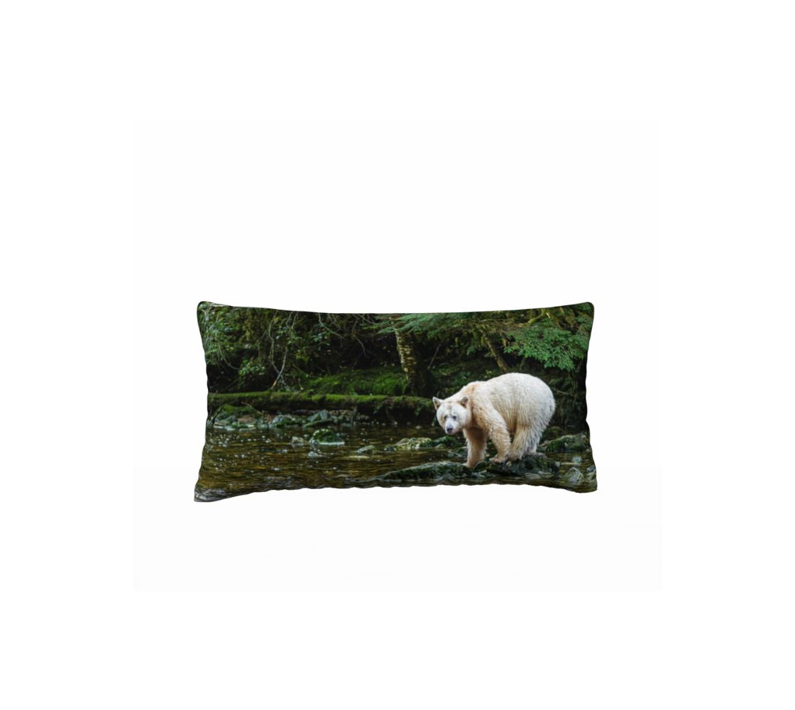 This 12 x 24 inch plush velveteen cushion cover features a white spirit bear standing on a green mossy rock watching for salmon. The background  is a mossy green ground cover with green trees and a little bit of golden green in the stream.