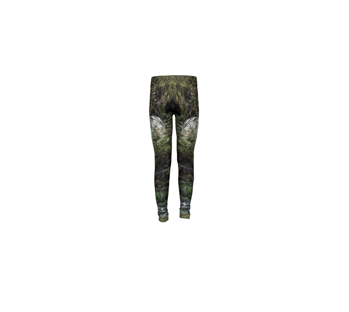 This is a rear profile of a pair of youth leggings featuring a photo of a spirit bear on each leg. The background is green.