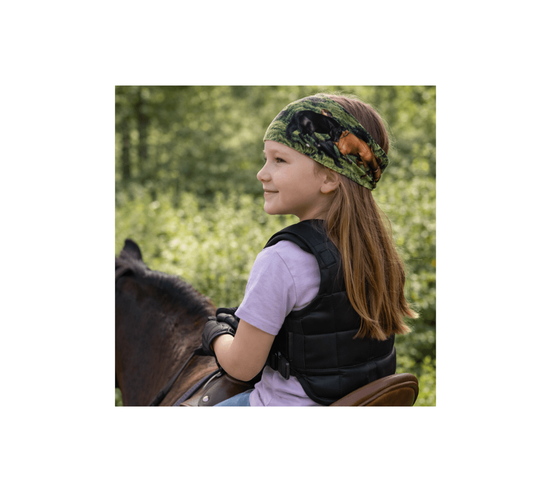 A young girl riding a horse wearing a band of wild horses head and neck buff from our real wildlife photography as a head band.