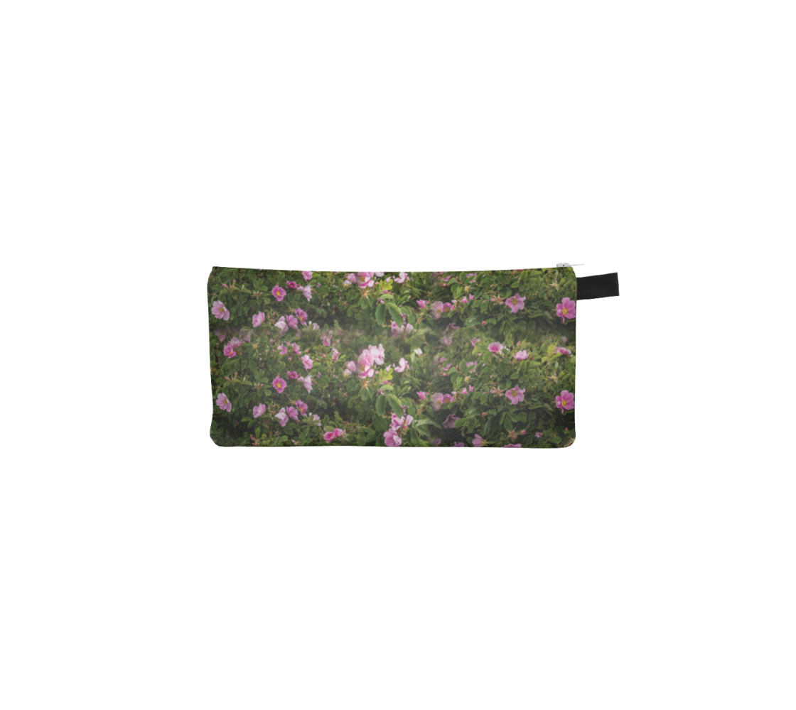 A zippered pouch with a collage of wild roses design with a green background.