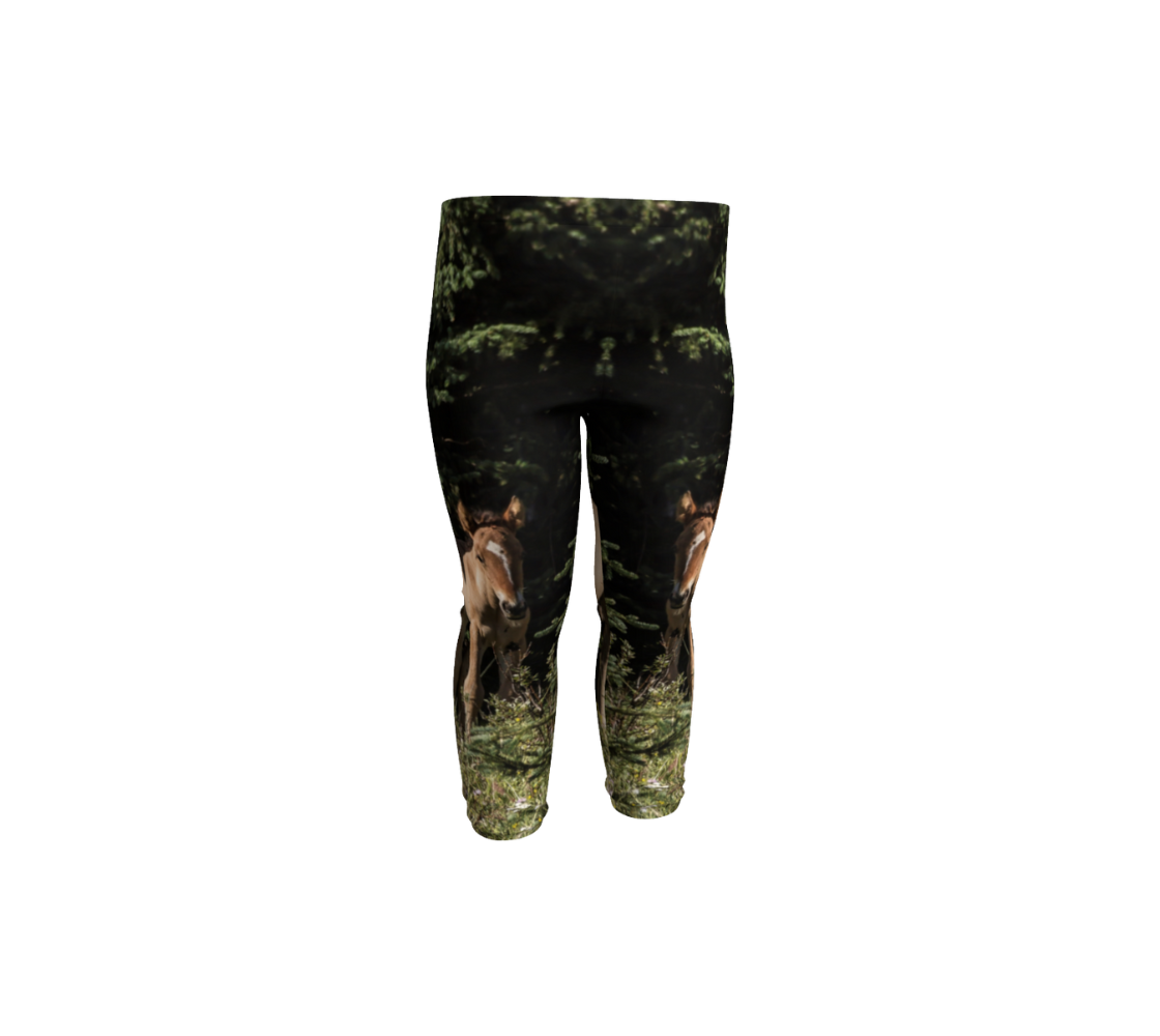 A front view of a pair of baby leggings with an image of a wild horse colt design with a black and green background.