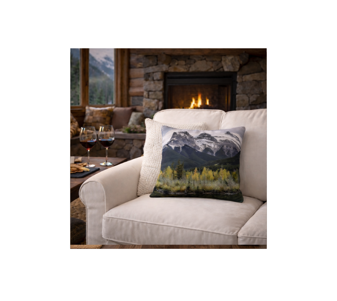 Decorative cushion cover with mountain  scenery design on a couch in a cozy living room setting.