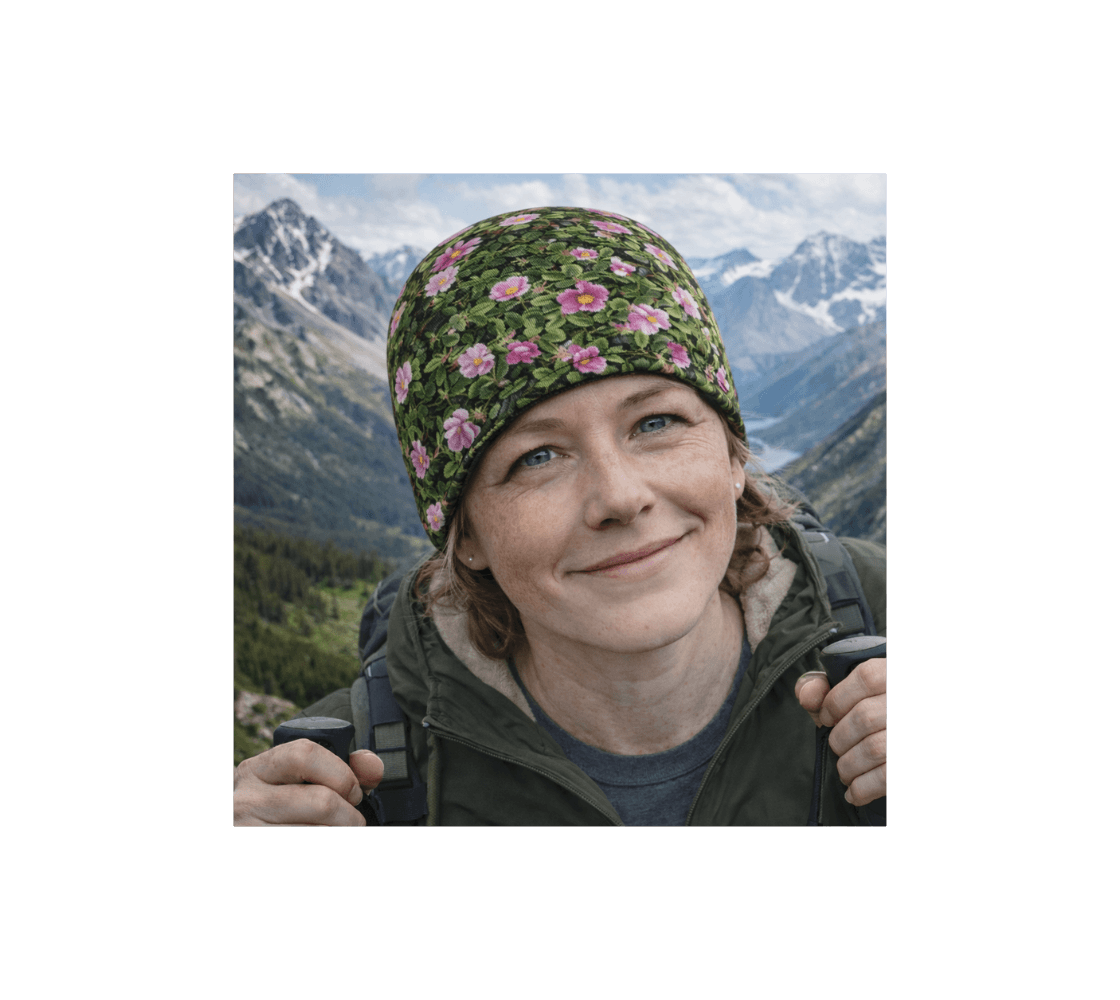A woman wearing a wild roses bamboo-lined beanie from our real Canadian nature photography standing with the mountains in the background.