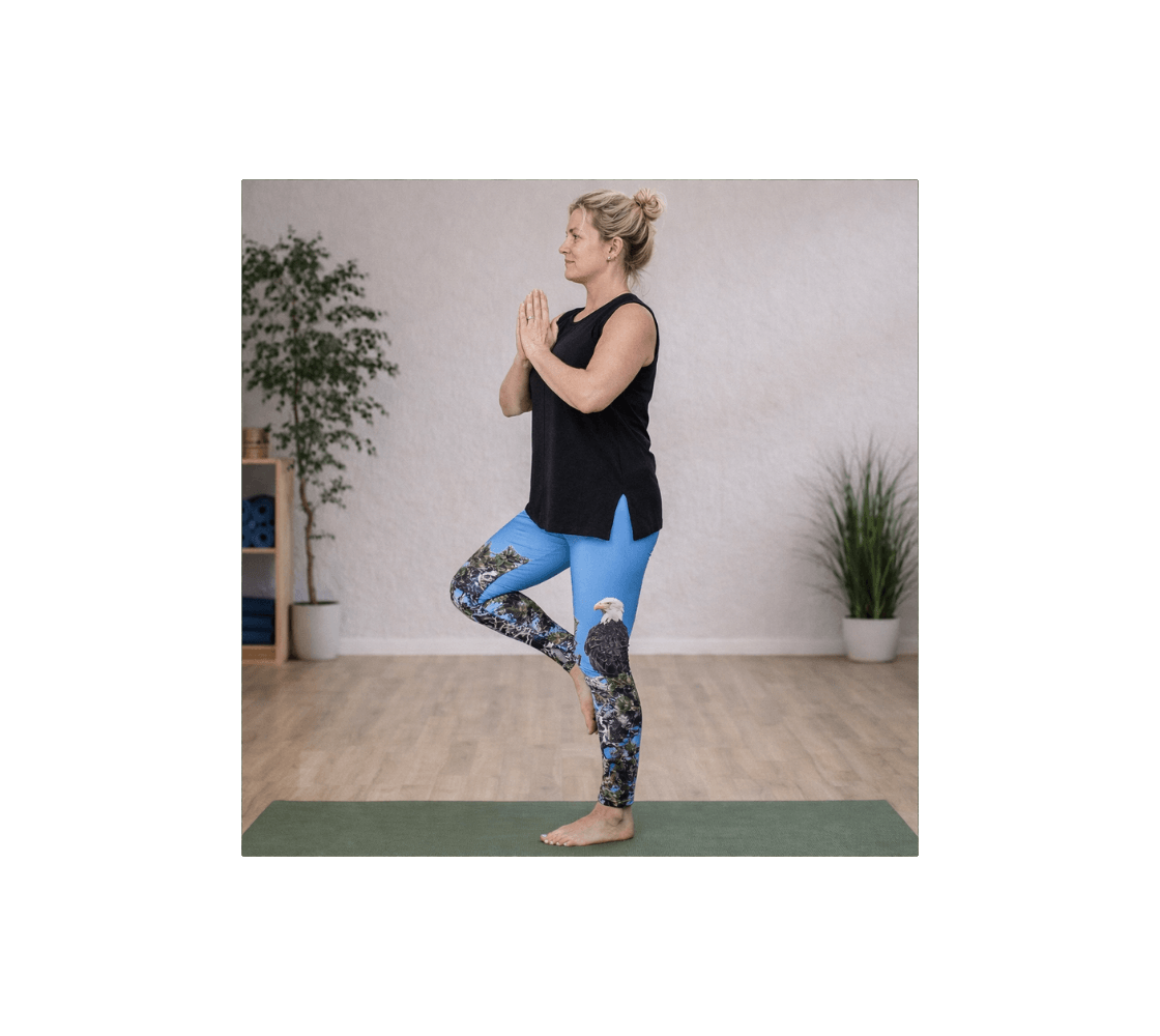 Woman practicing yoga wearing pair of bald eagle yoga leggings from our wildlife photography in a studio.