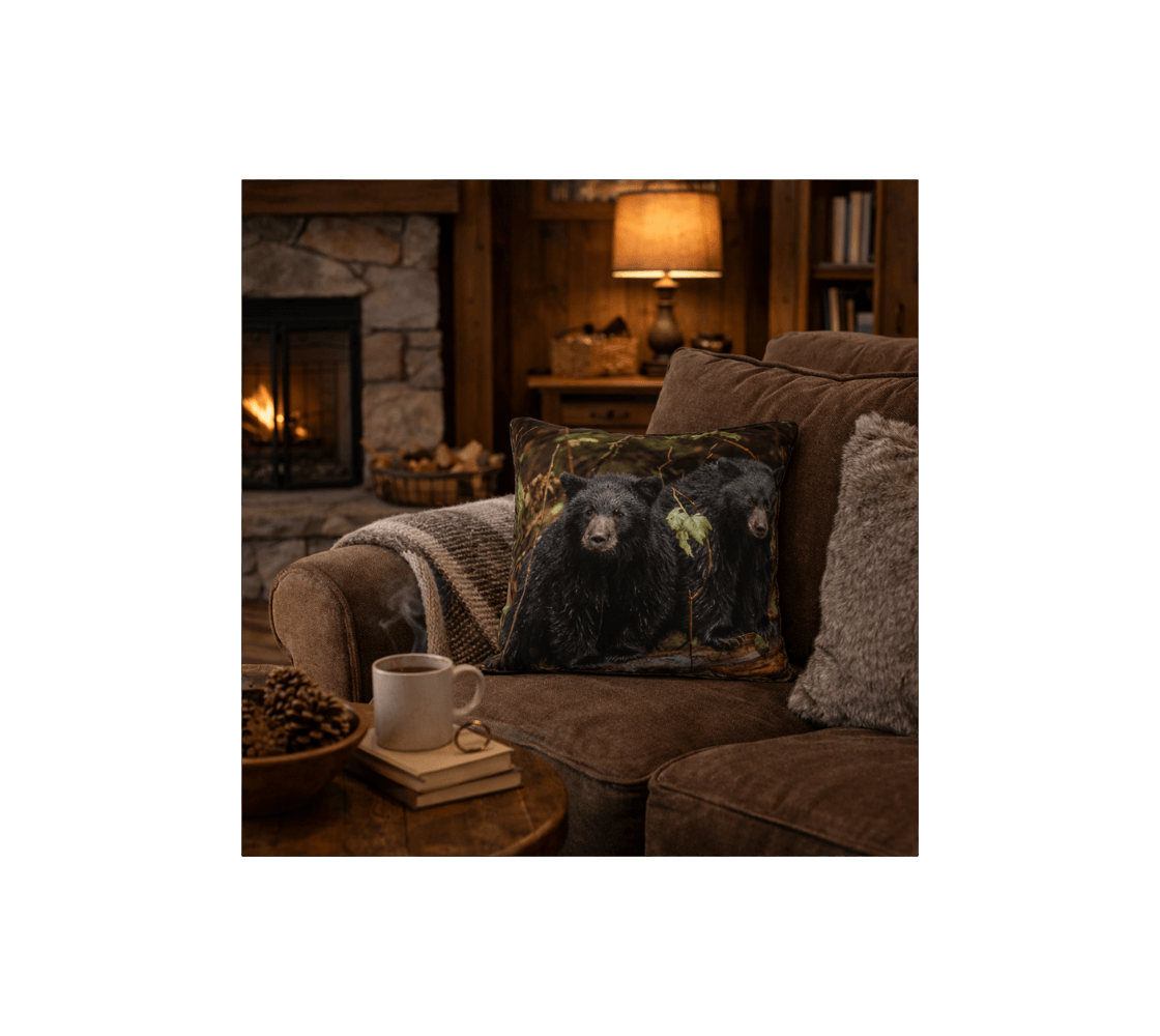 A cozy living room with a  black bear cubs decorative throw pillow cover from our wildlife photography on a brown couch.