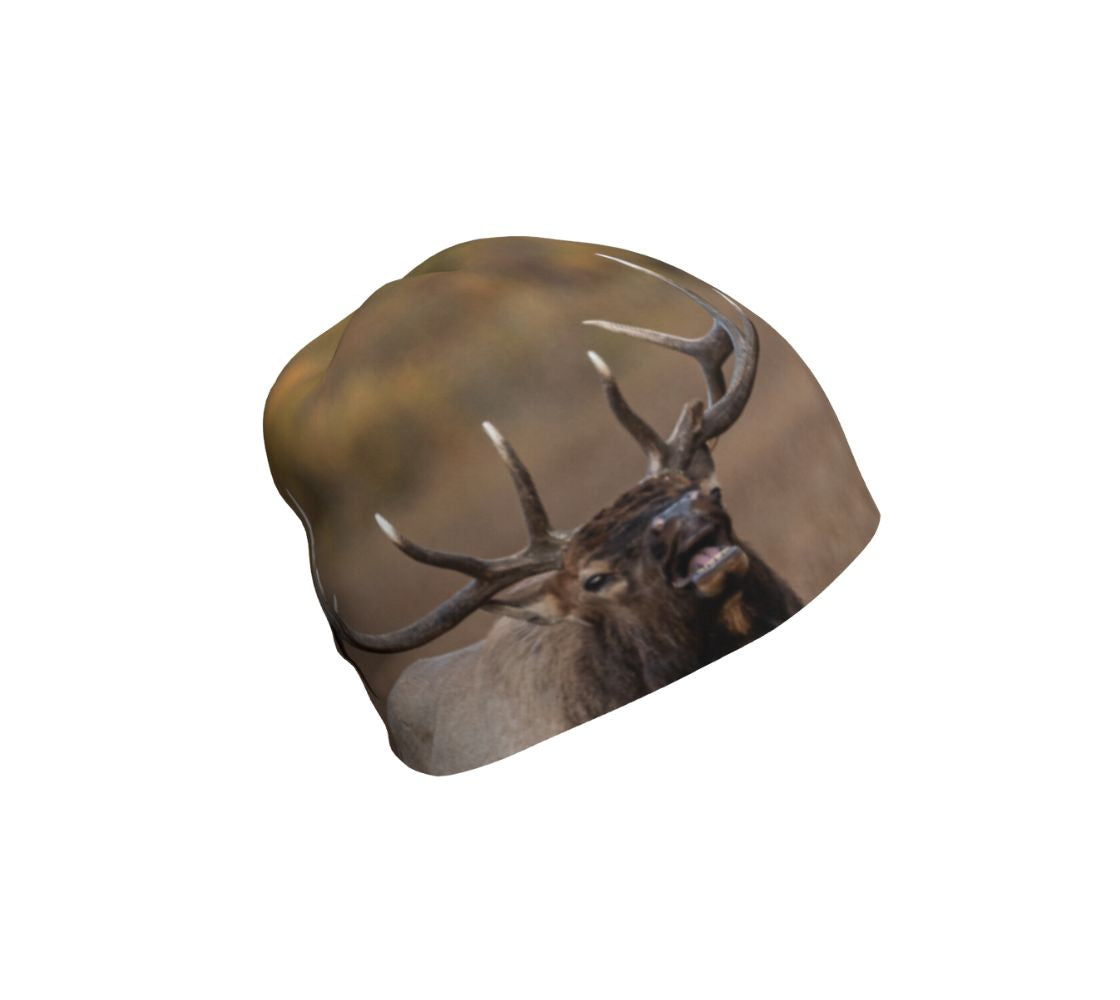 A photograph of a bull elk on a beanie. Background is of mottled browns and yellows with an image of a headshot of a elk with its mouth open bugling.