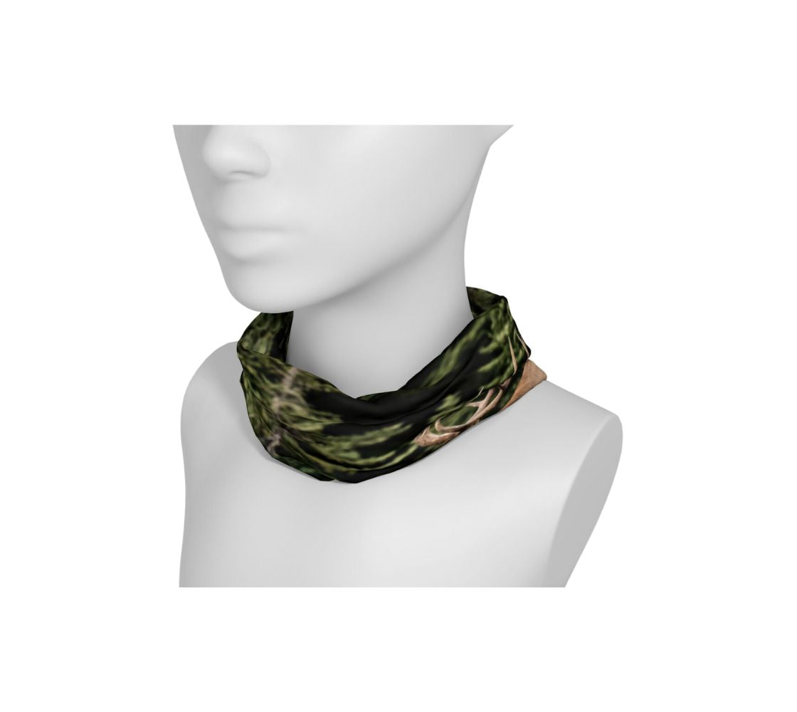 A mannequin head with a head and neck buff wrapped around the neck with a image of a bull elk design with a green background.