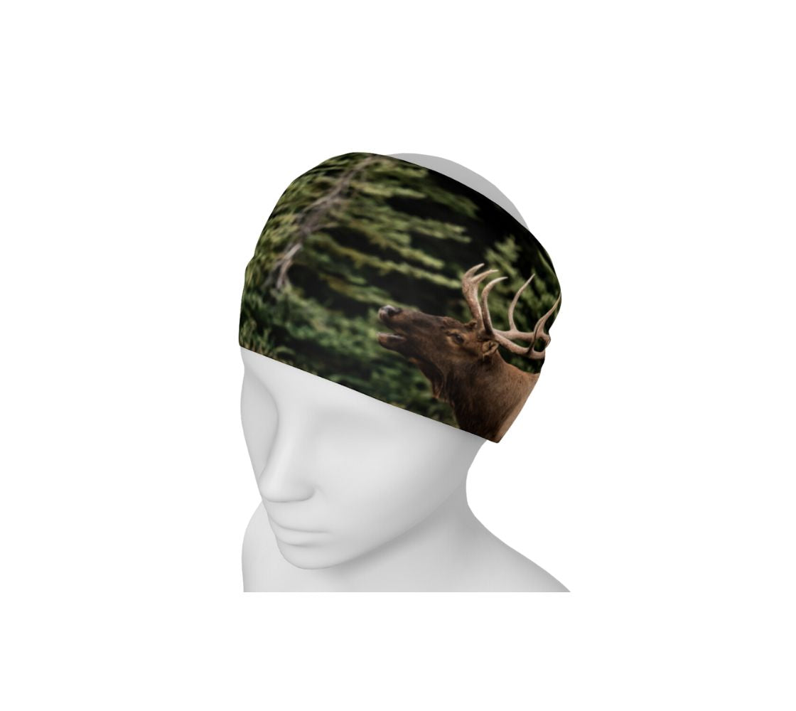 This is a photograph of a bull elk bugling on a head and neck buff worn as a headband on a mannequin. The background is blurred yellow dead grass. The dark brown and tan colored elk with its large antlers is raising its head as it bugles out its mating call.