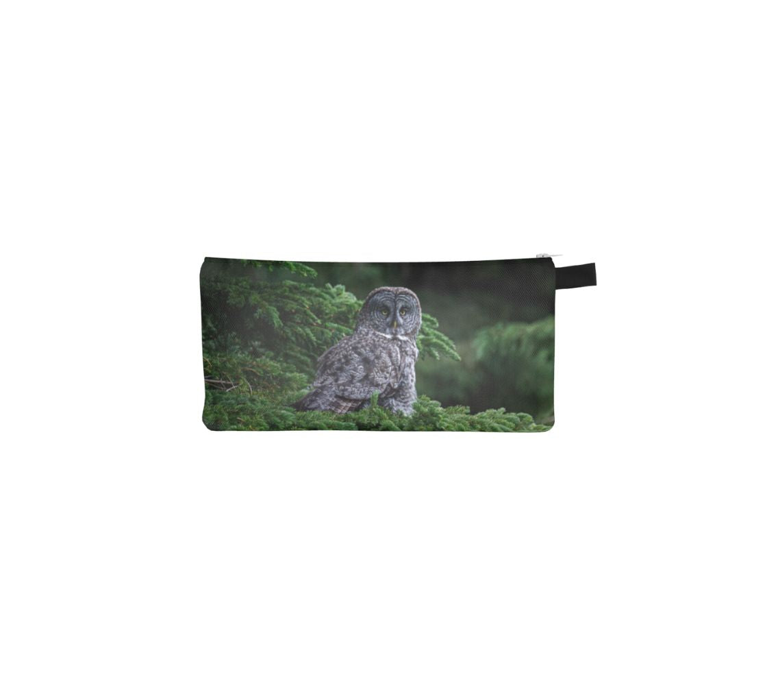 This durable double sided 9” x 4” canvas zippered pouch features 2 real photos of a great grey owl. On this side is a great grey owl sitting on a green spruce tree branch, looking directly at you. 