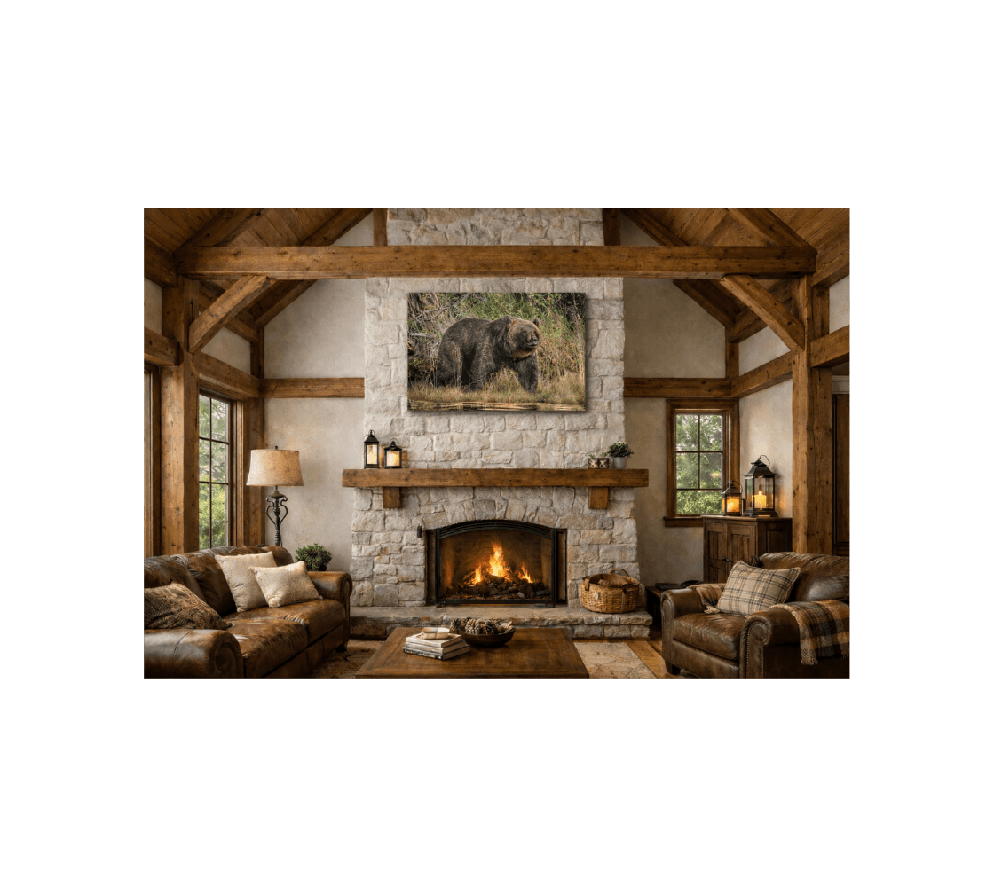 A cozy living room with a canvas print of a grizzly bear from our real wildlife photography hanging above a stone fireplace.