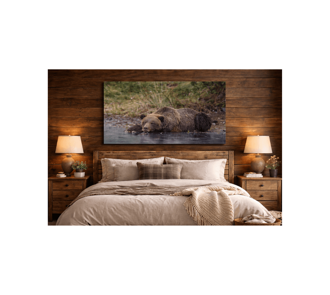 A bedroom with a canvas print of a grizzly bear from our real wildlife photography hanging above the headboard of a bed.