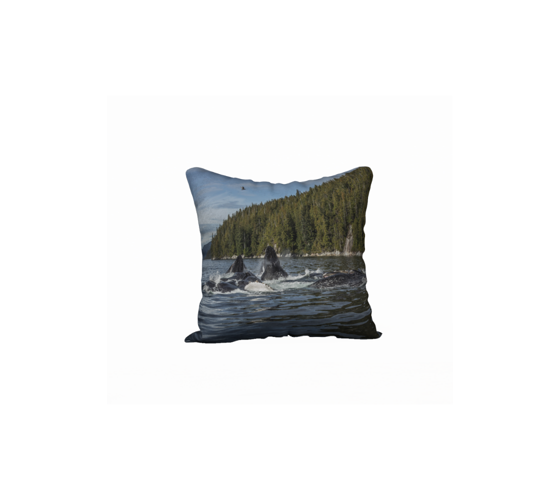 A throw pillow cover featuring an image of humpback whales bubble-net  in a coastal setting.