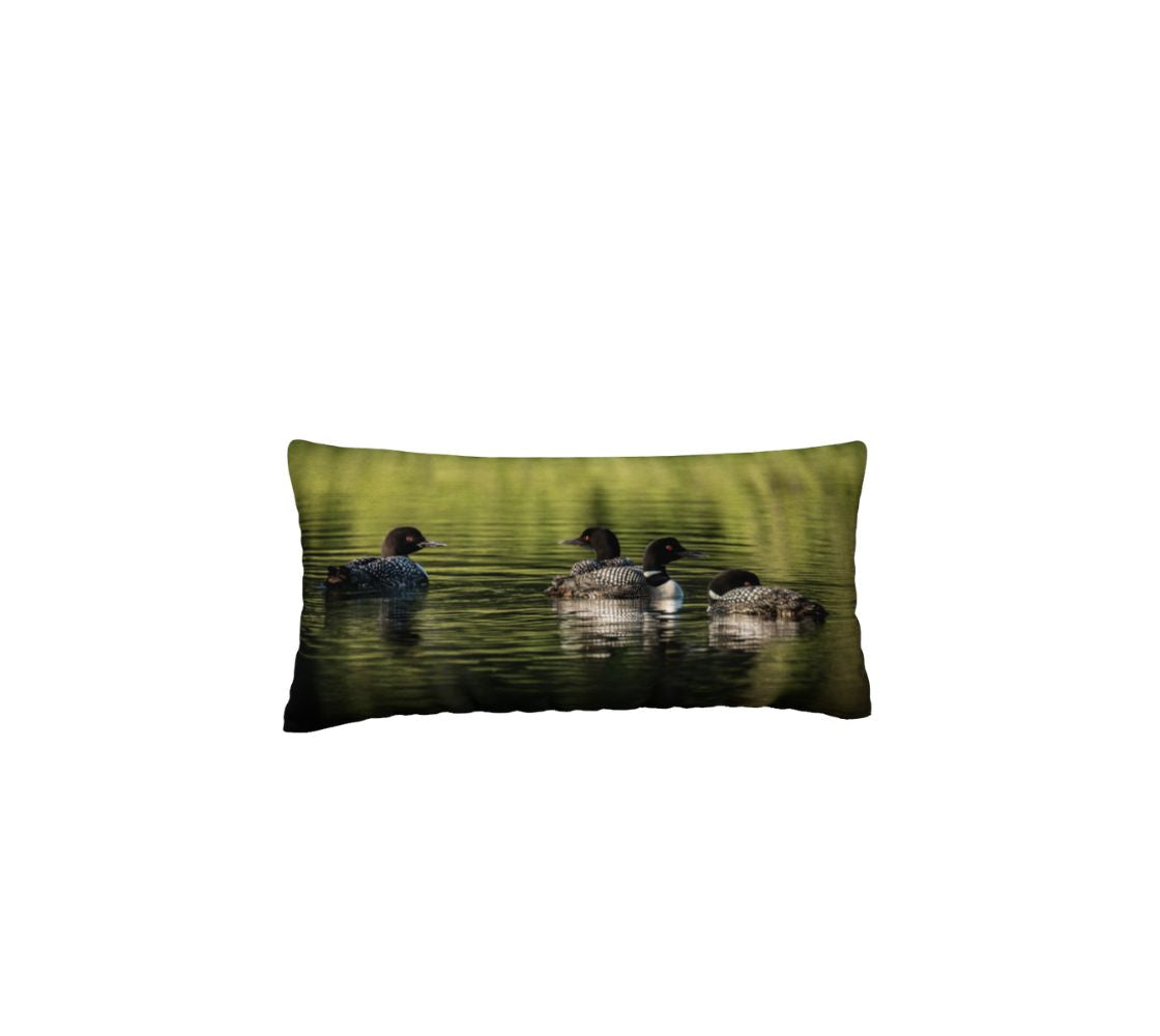 Decorative 12" x 24" pillow with 4 loons on water. Pillow is placed on a white background
