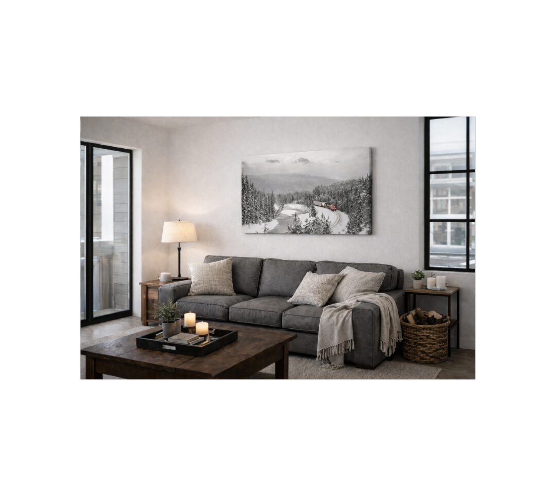 Living room with a gray sectional sofa, coffee table, and canvas print of train