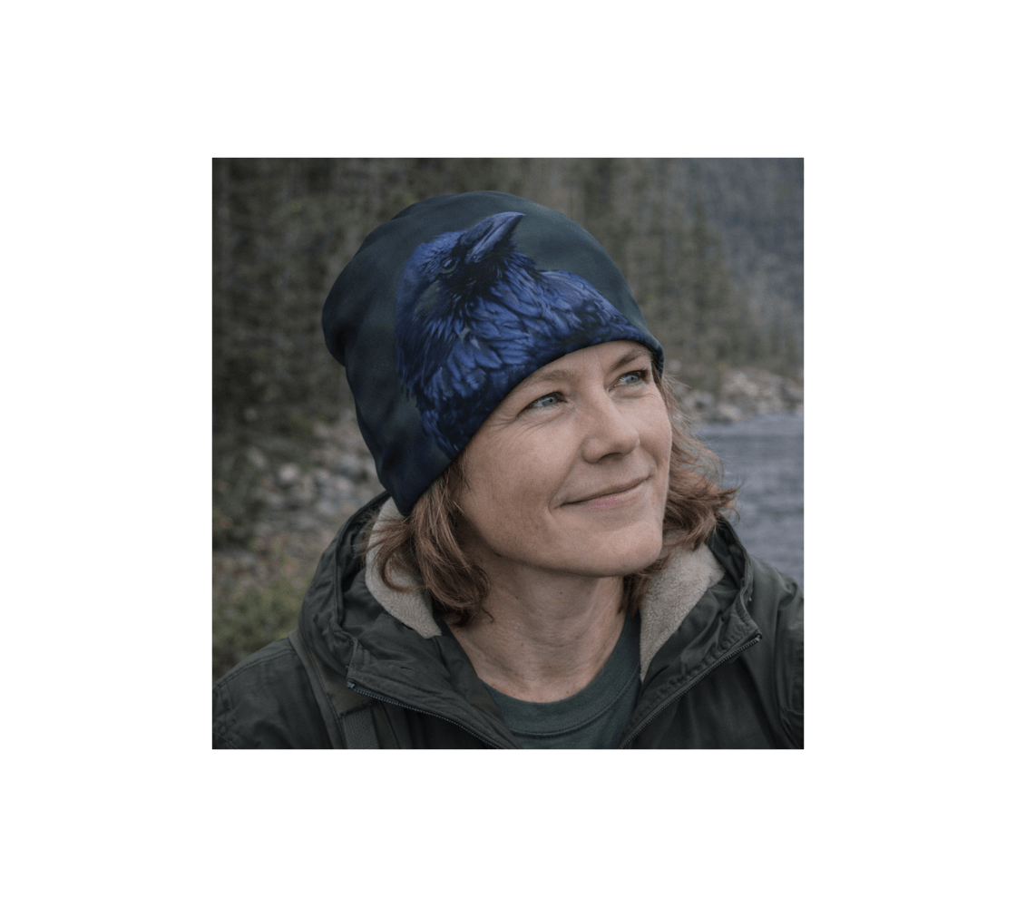 A woman standing wearing a raven bamboo-lined beanie from our real wildlife photography by river.