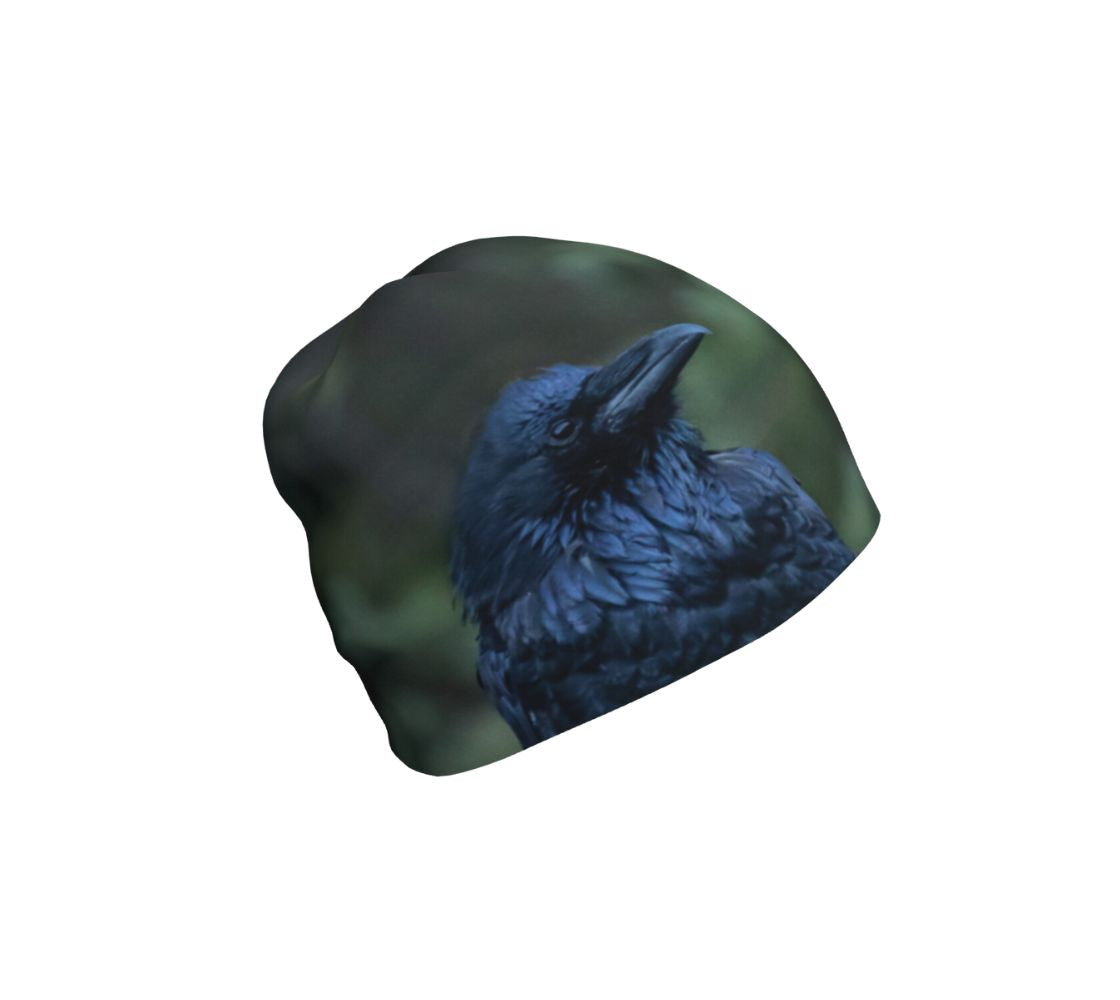 A bamboo-lined beanie with an image of a raven design with a green background.