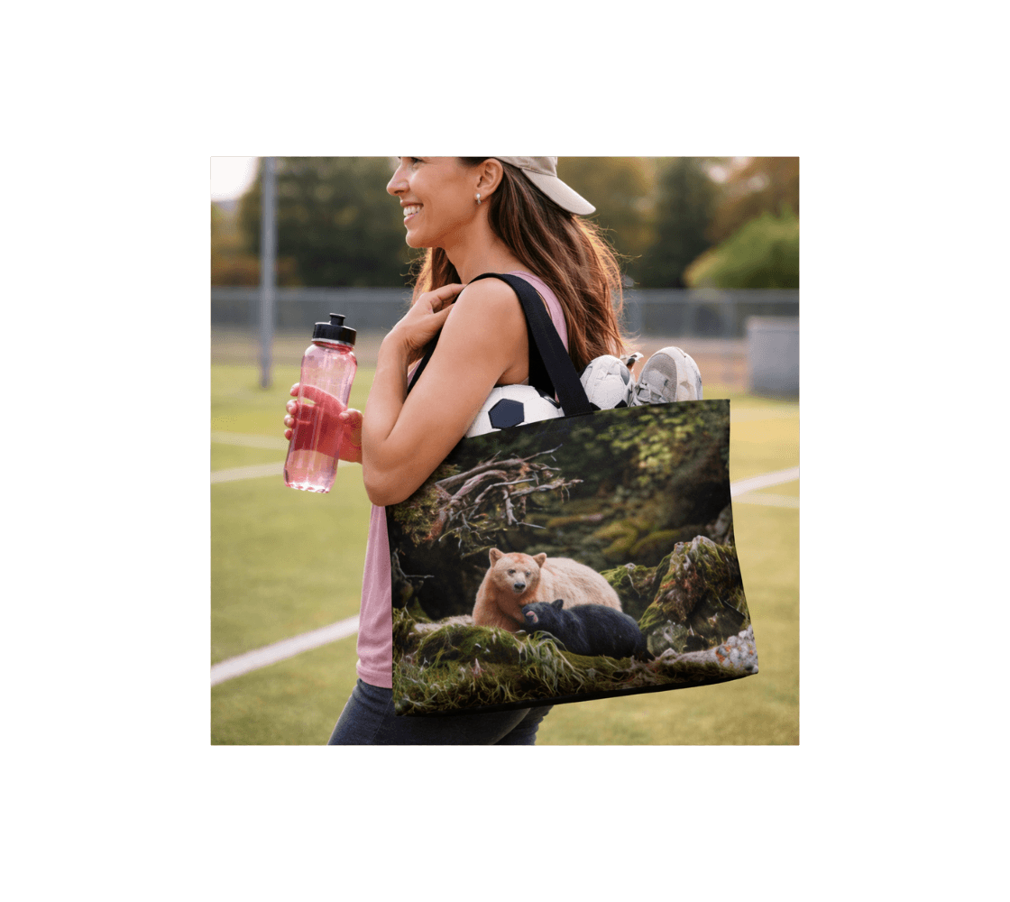 A woman carrying a spirit bear large tote bag from our wildlife photography with a soccer ball and shoes in it.
