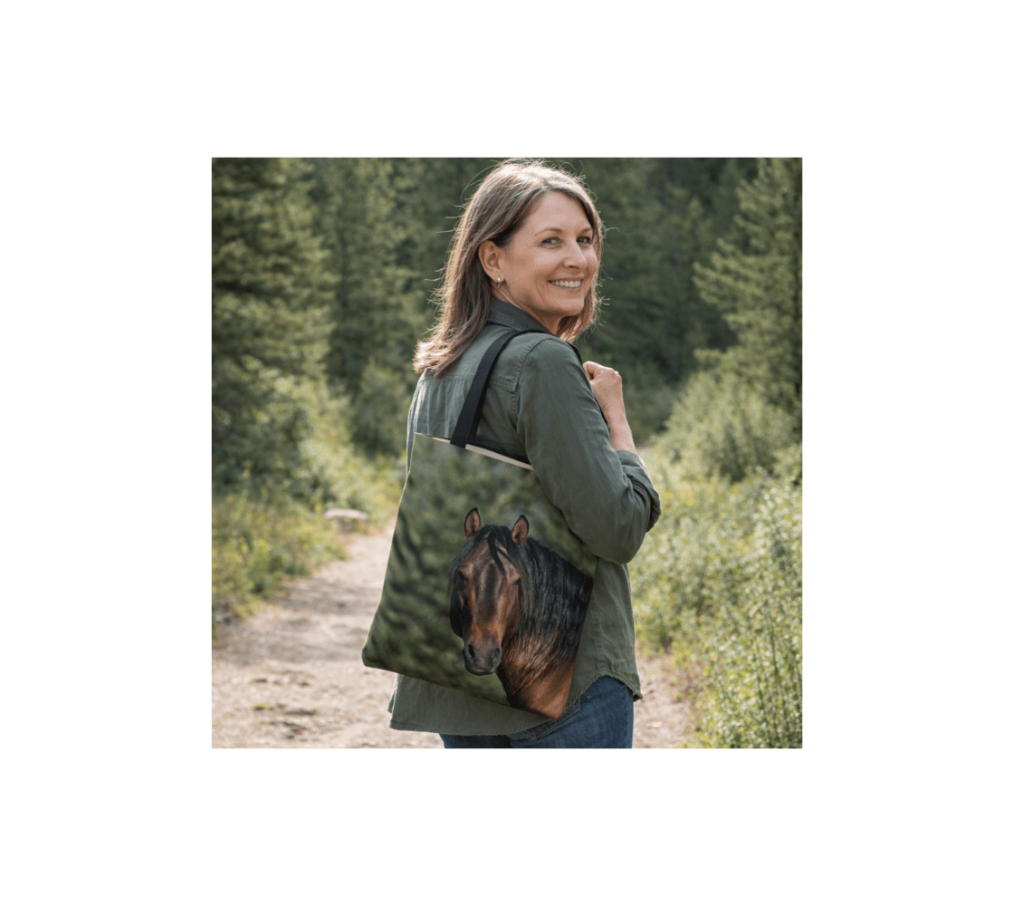 A woman carrying wild horses medium reusable tote bag from our real wildlife photography in a forest setting.
