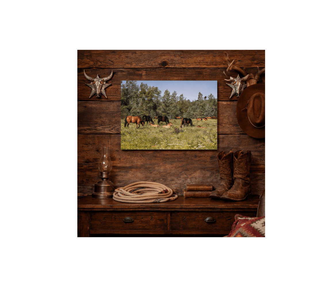 A wooden wall with a band of wild horses metal print from our real wildlife photography hanging above a side broad table.