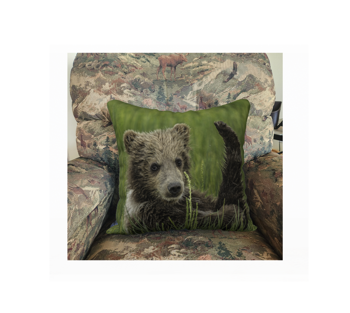 A Canadian-made soft plush velveteen cushion cover featuring a real North American wildlife image of a grizzly bear cub. Solid black velveteen on the reverse side with a durable hidden zipper. Measures 18” x 18”.