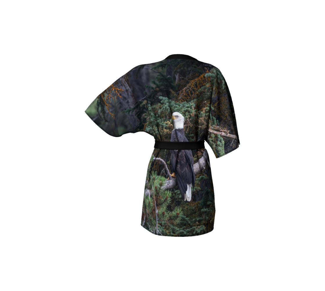 A back view of a kimono coverup featuring a bald eagle design with a green background. 
