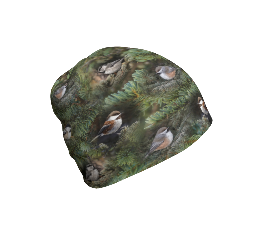 This is an image of a photo of a collage of chickadees on a beanie. The background is a repeating collage of green tree boughs, with repeating images of the four different chickadees of Western Canada in their colorful black, brown, white, rust and grey tones.