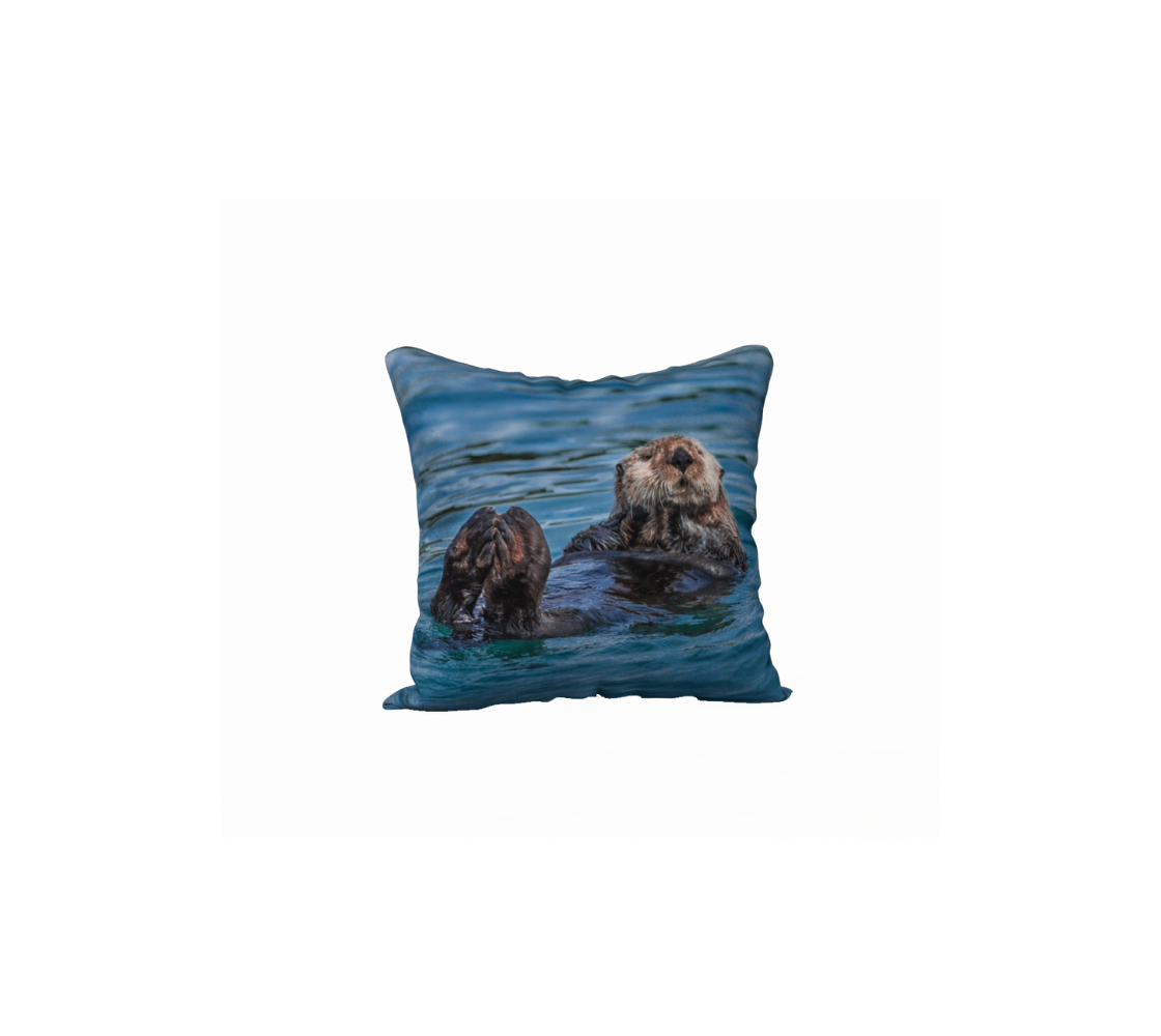 A throw pillow cover featuring an image of sea otter design with a blue background.