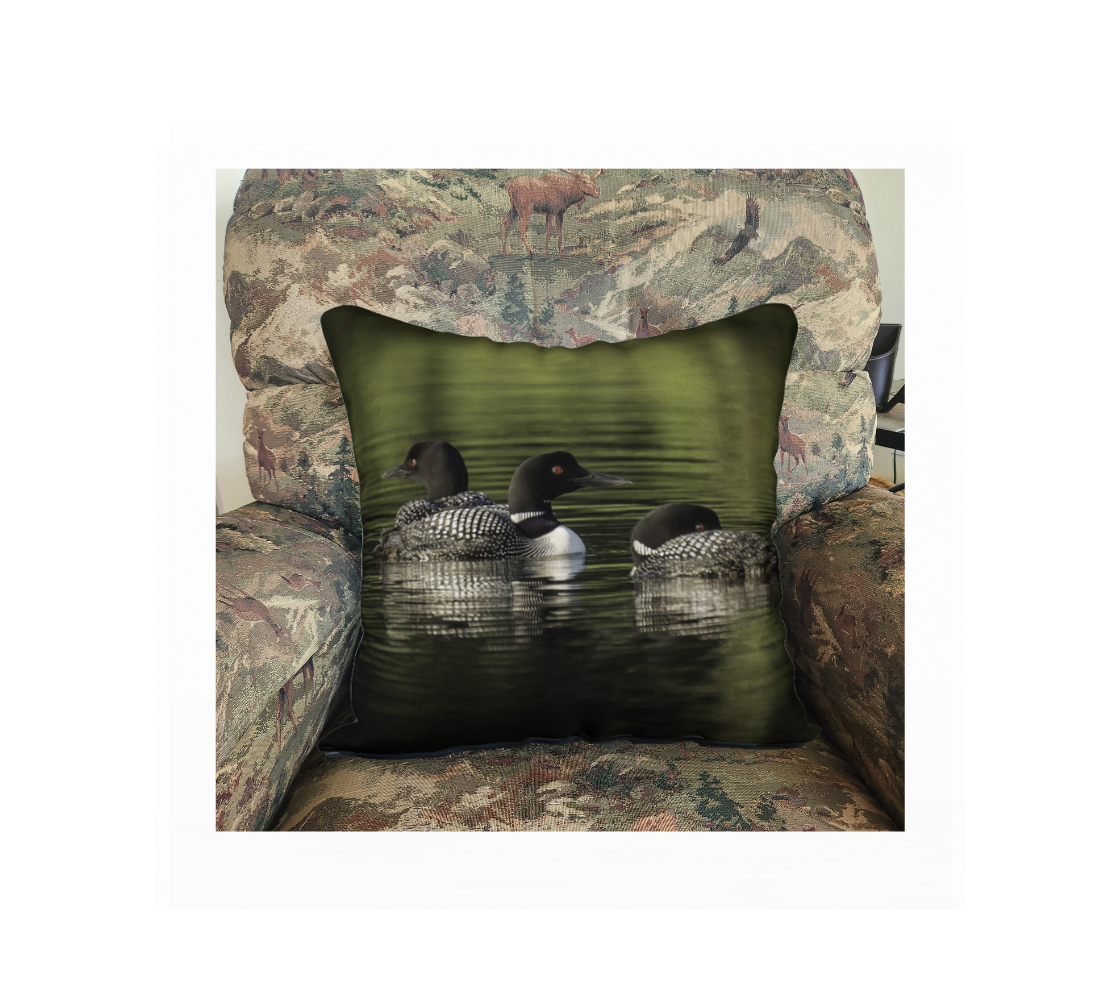 A Canadian-made soft plush velveteen cushion cover featuring real North American wildlife images of common loons. Solid black velveteen on the reverse side with a durable hidden zipper. Measures 18” x 18”.